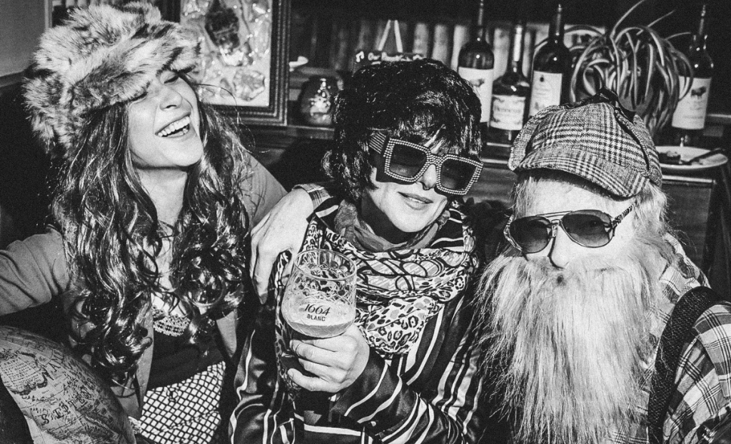 Black and white photo of Itchy Valentine, Debbie J. Russel and Peter Wade having fun and laughing.