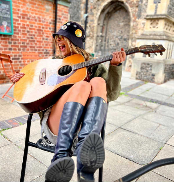 Photo of Itchy Valentine with a guitar