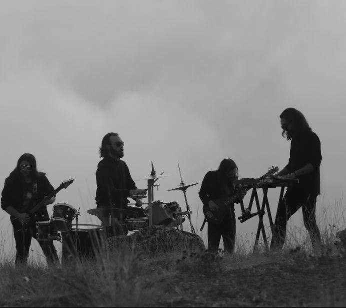 Black and white photo of a four man band playing music outside