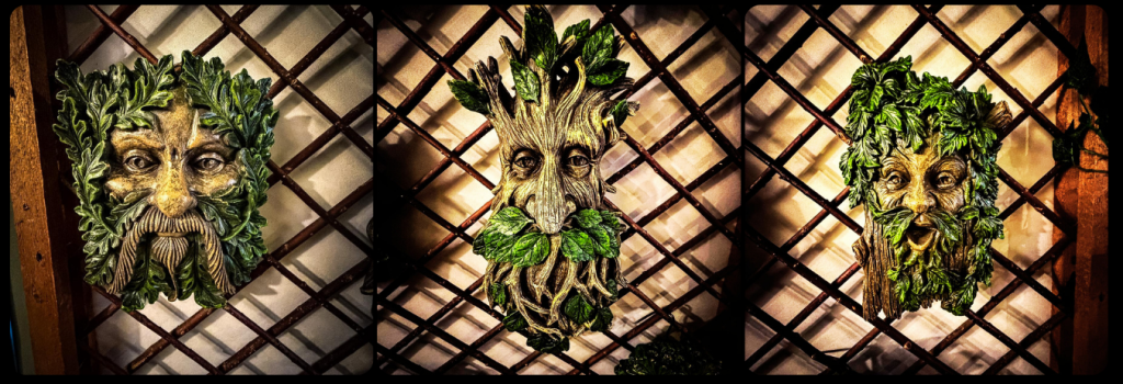 Photo of three Green Man wall plaques